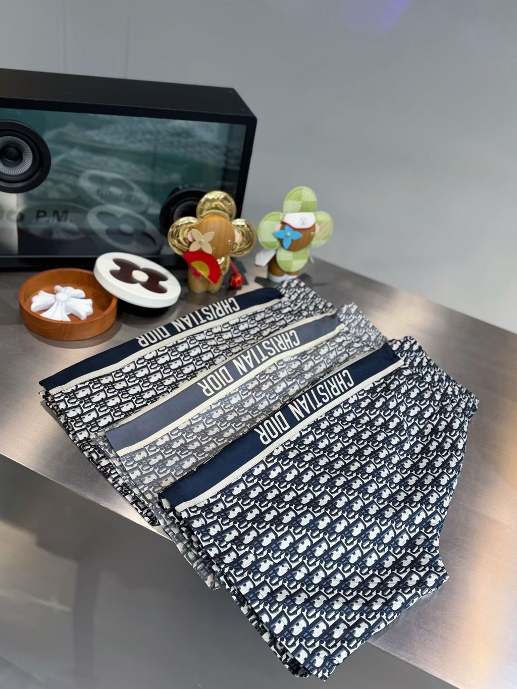 All-over logo print pants with dark blue waist stripe, folded with waistband visible