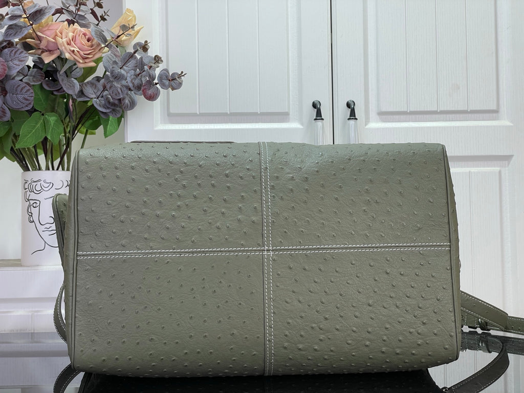 Louis Vuitton olive green duffel-style bag with centered seam and shoulder strap