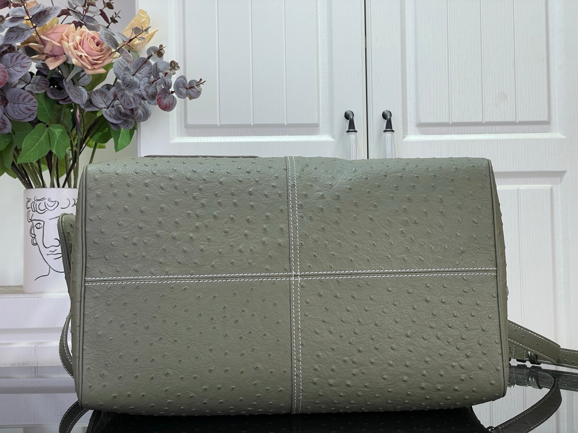 Louis Vuitton olive green duffel-style bag with centered seam and shoulder strap