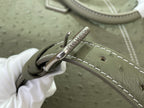 Louis Vuitton olive green bag with stitched strap and metal clasp hardware