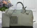 Louis Vuitton bag in olive green with top handles, front pocket, and chain detail