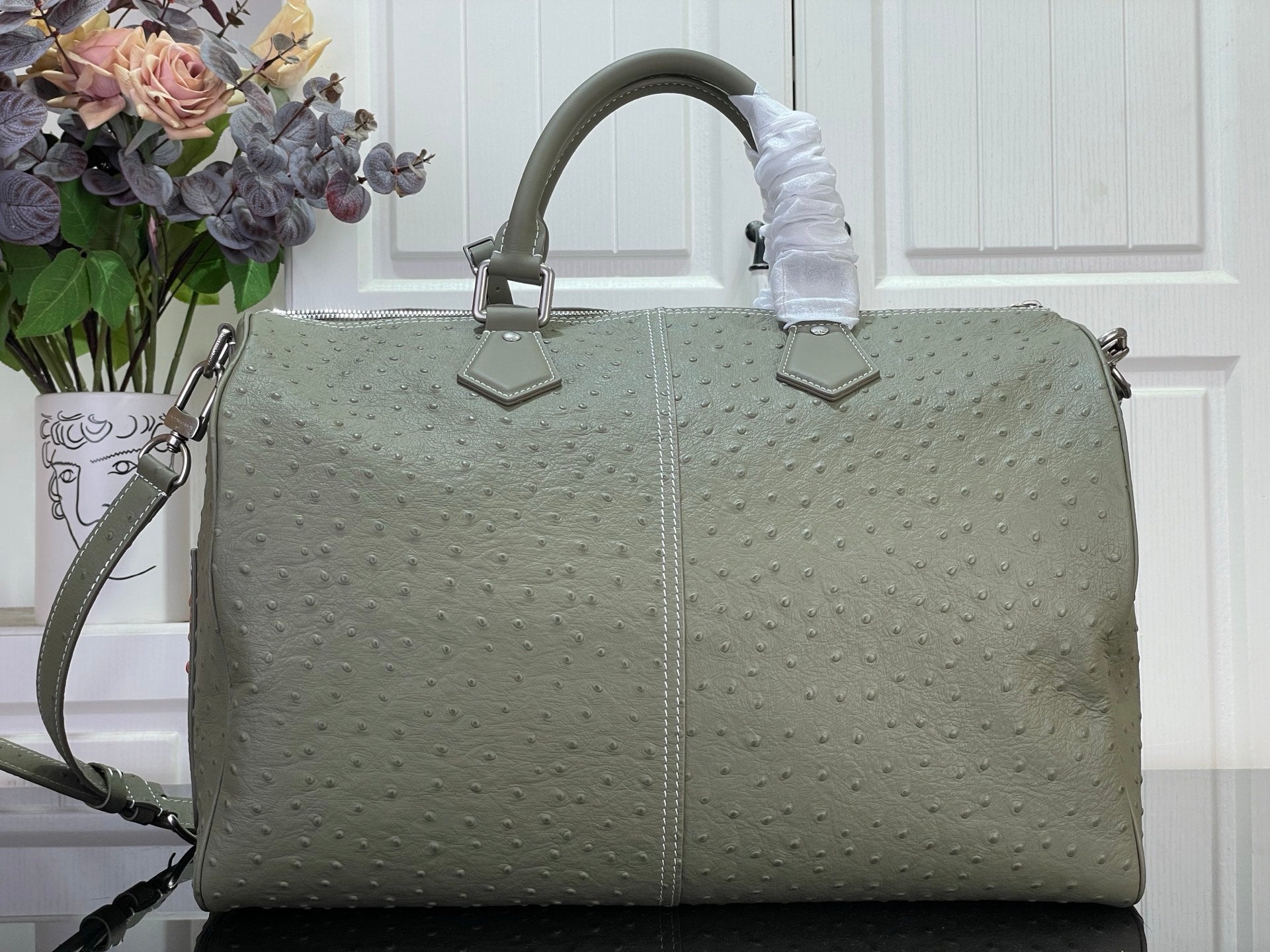 Louis Vuitton olive green structured bag with top handles and side shoulder strap