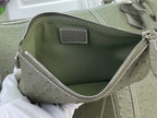 Open sage green Louis Vuitton bag with fabric lining and top zipper