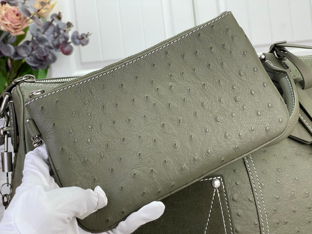Sage green Louis Vuitton small handbag with front panel and side hardware