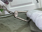 Sage green Louis Vuitton bag zipper pull with silver ring hardware