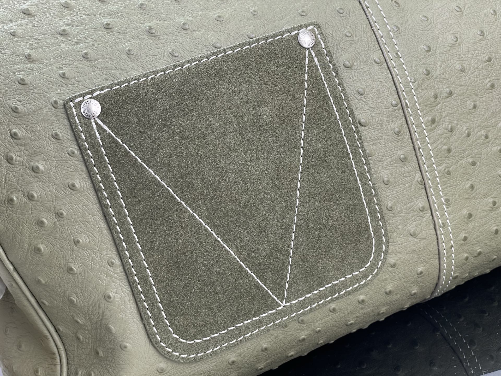 Louis Vuitton olive green front pocket with stitched trim and diamond-style corner seams