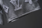 Gray pants with appliqué letters near hem