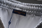 Gray sweat shorts with Louis Vuitton Paris brand label inside waistband