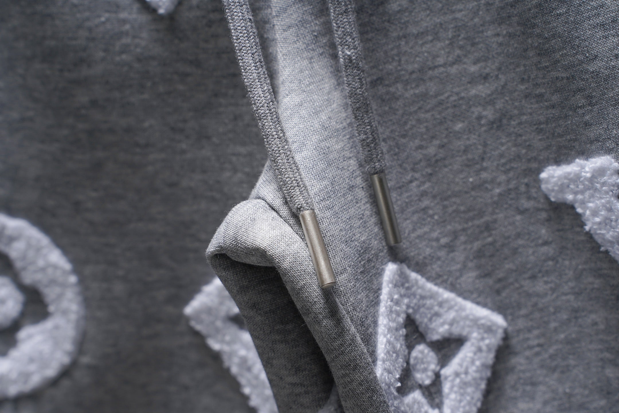 Gray sweat shorts drawstring tips and pocket area, monogram pattern