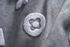 Gray pants with heart-shaped appliqué logo patch