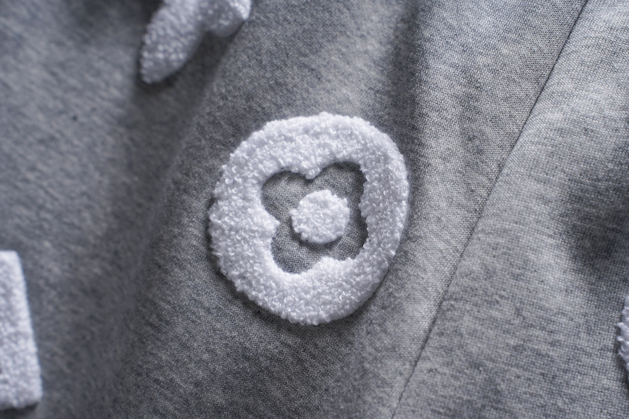 Gray pants with heart-shaped appliqué logo patch