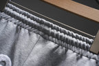 Gray monogram sweat shorts waistband close-up with elastic stitching