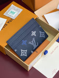 Small navy wallet with repeating white and blue logo pattern, visible card slots.