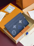 Small navy wallet with multicolor logo motifs, stitched edges, and card slot panel.