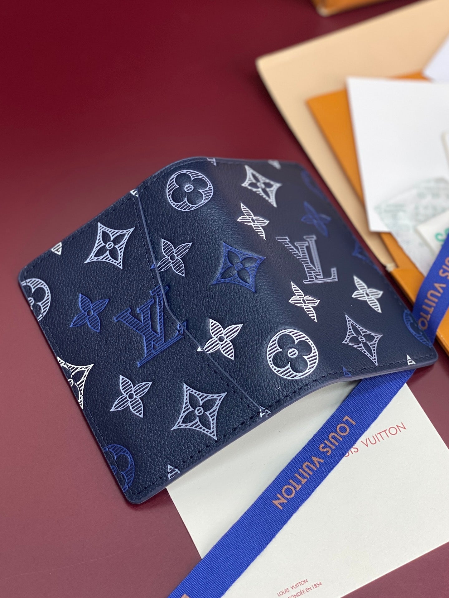 Louis Vuitton blue monogram card holder with repeating butterfly and LV symbols