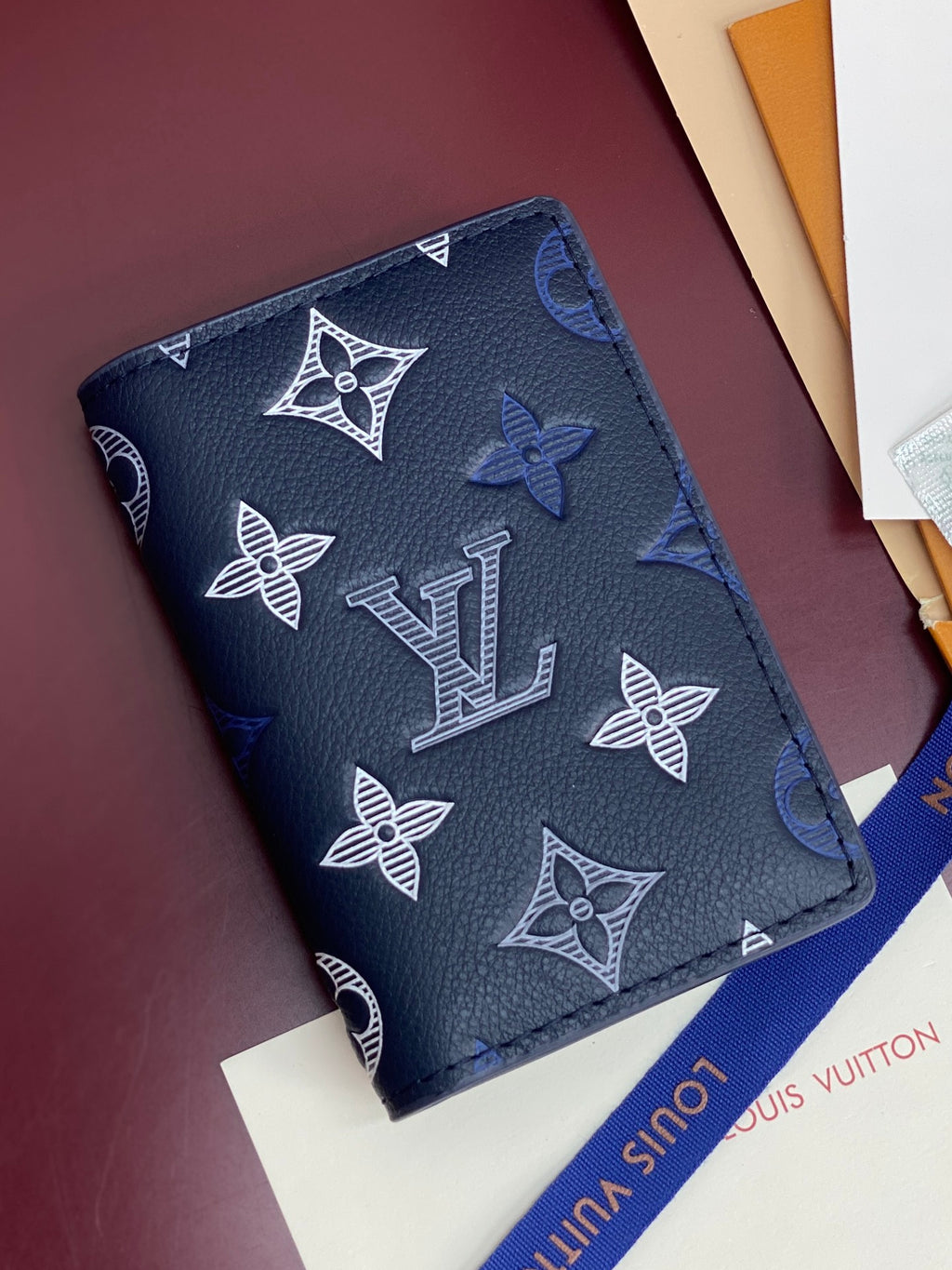 Blue Louis Vuitton small bag with LV and butterfly motifs, strap side view
