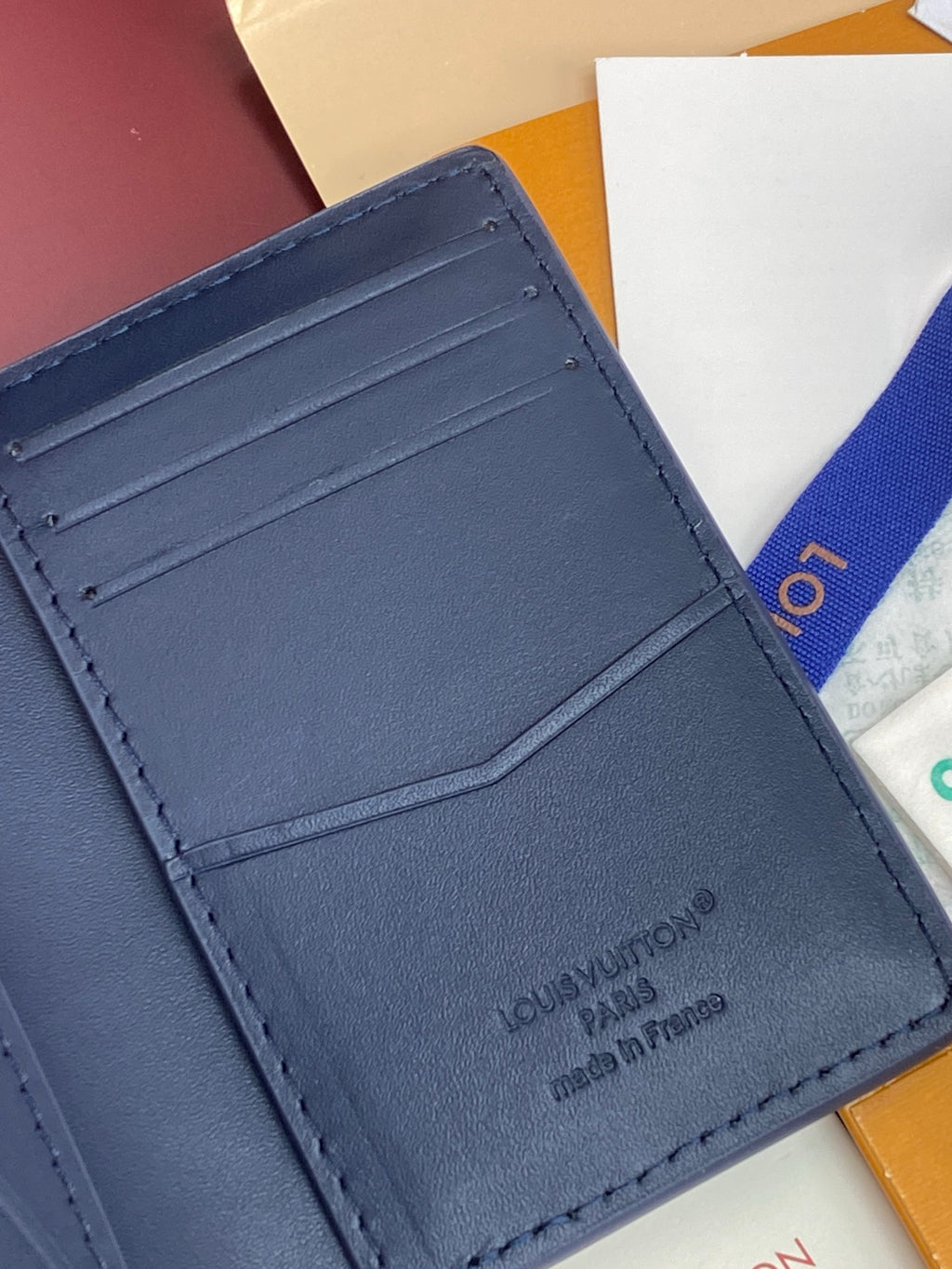 Blue Louis Vuitton small bag interior showing card slots and stitching details