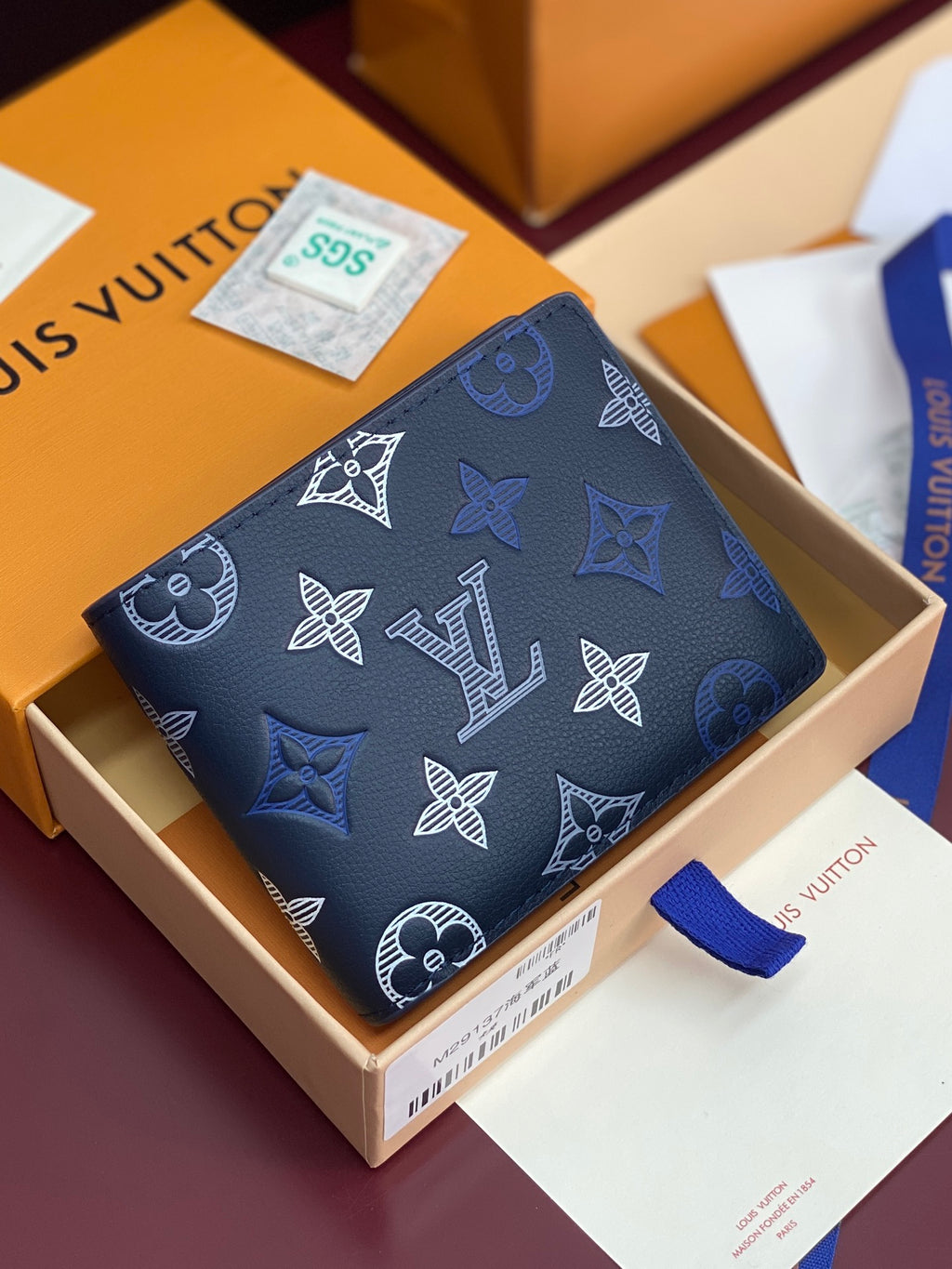 Louis Vuitton small wallet with navy monogram pattern and top snap closure