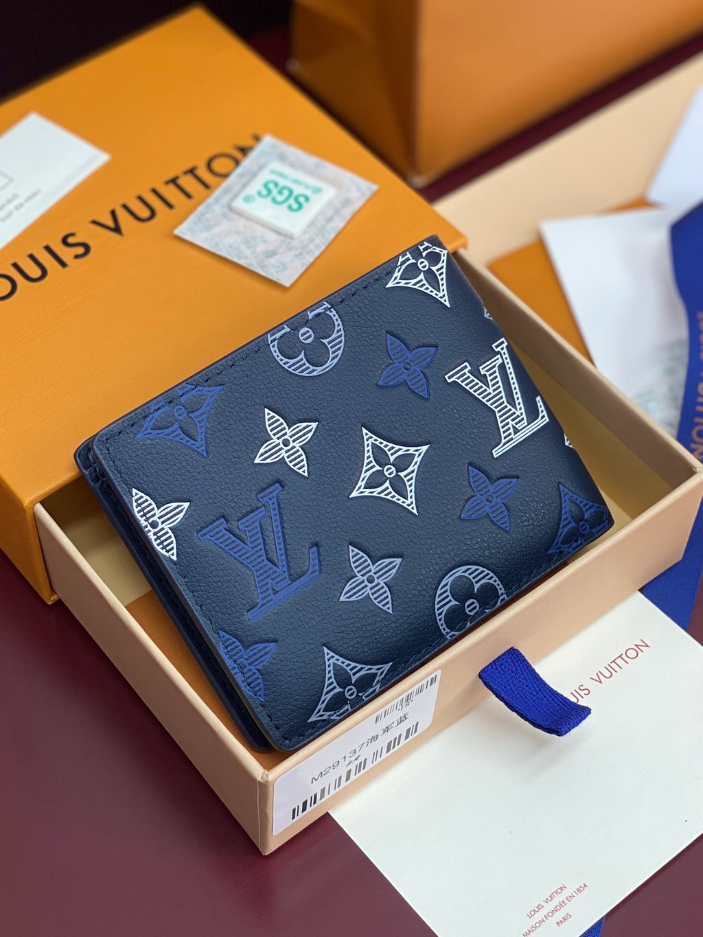 Louis Vuitton blue monogram wallet, patterned exterior with corner view