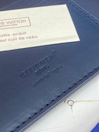 Louis Vuitton small wallet blue leather with embossed logo and stitched edge