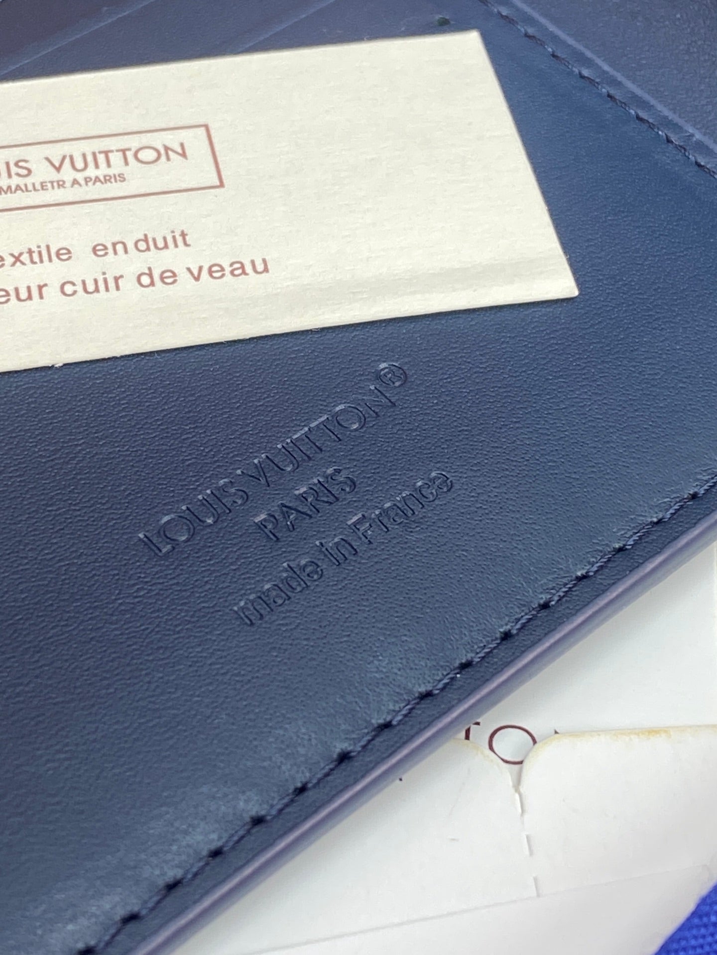 Louis Vuitton small wallet blue leather with embossed logo and stitched edge