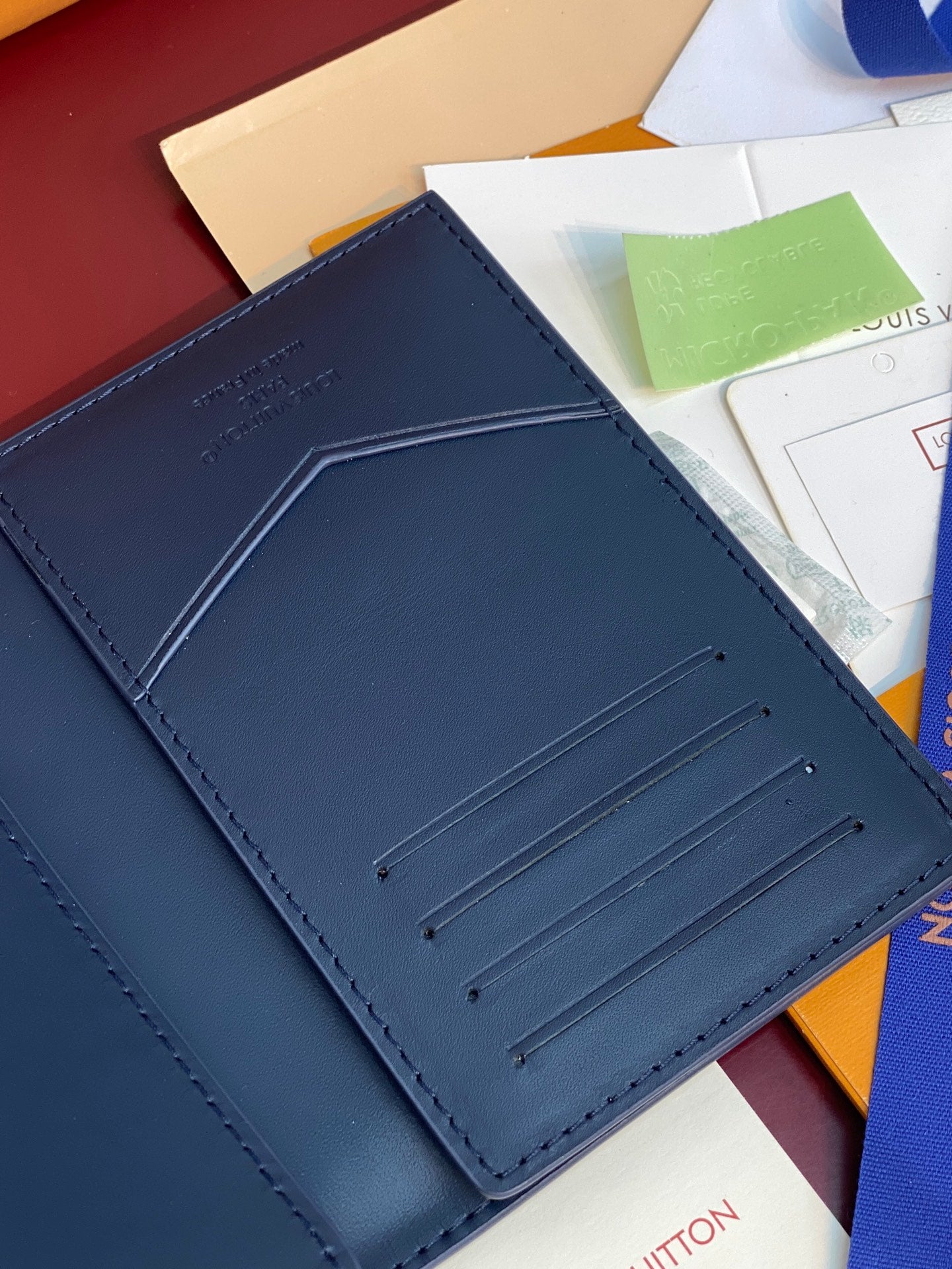 Louis Vuitton card holder close-up of navy blue card slots and stitched panel
