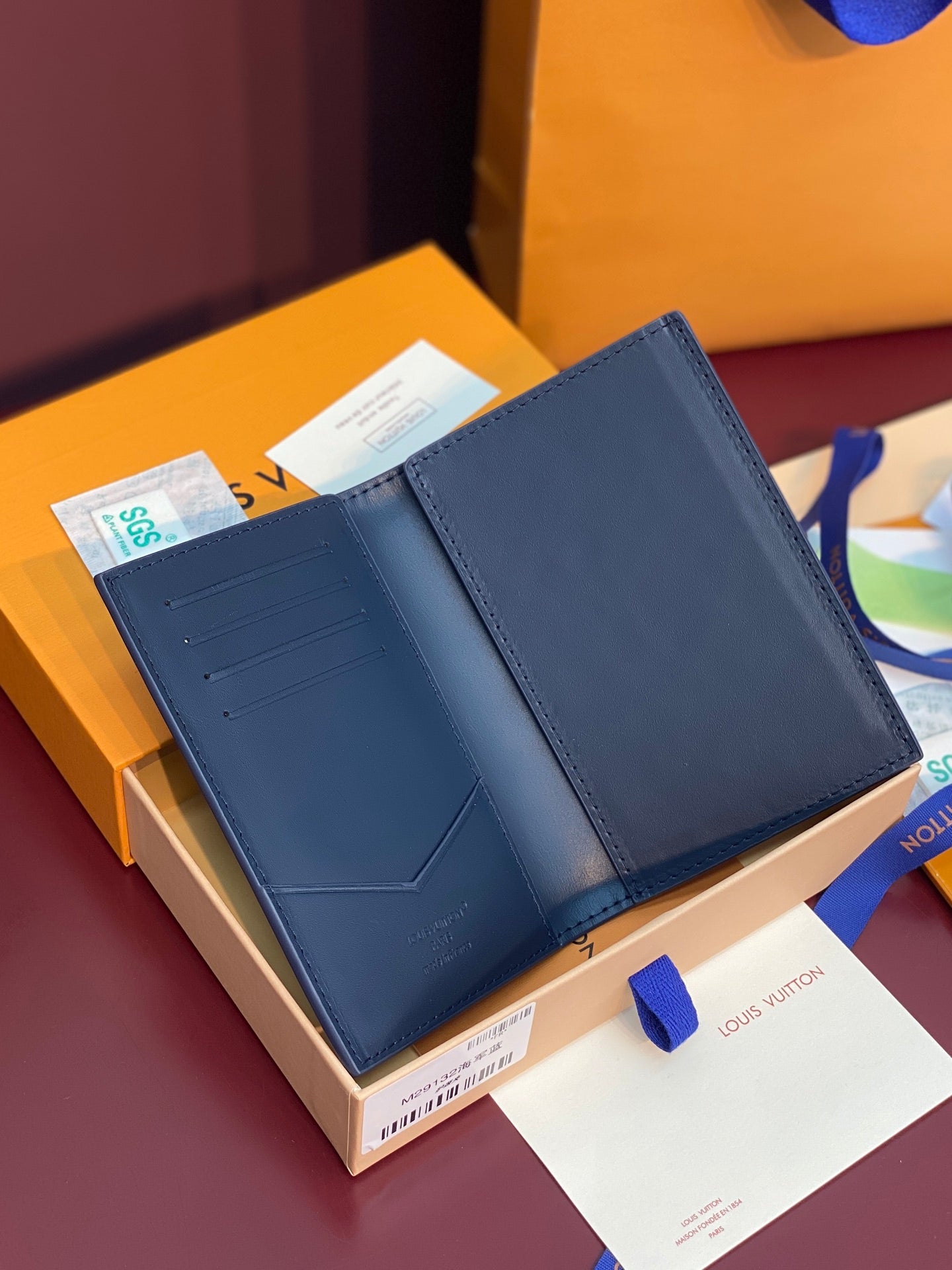 Louis Vuitton card holder open view in navy blue with card slots and stitched edges