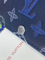 Louis Vuitton metal button and dark blue monogram print on leather surface