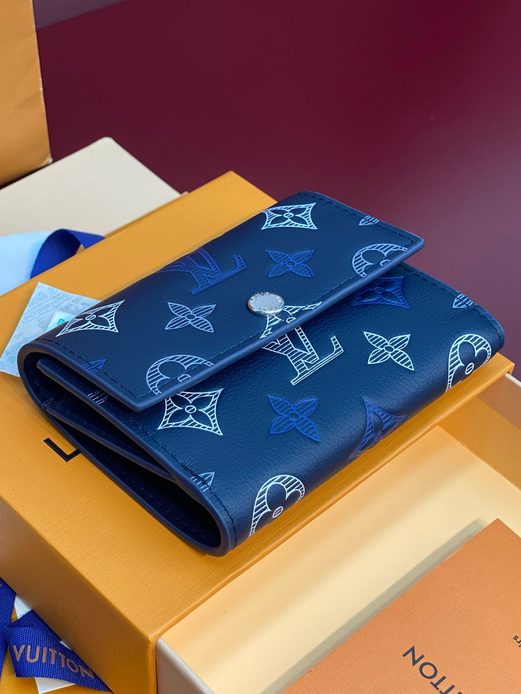Louis Vuitton small bag, dark blue leather with repeating monogram icons and fold-over flap