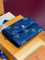 Louis Vuitton small bag, dark blue leather with repeating monogram icons and fold-over flap