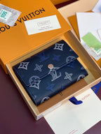 Louis Vuitton zip wallet in dark blue with monogram pattern and gold-tone hardware