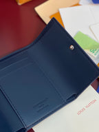 Navy leather wallet interior with stitched edges and snap button