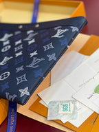 Blue Louis Vuitton small bag corner view with monogram print on flap.