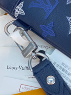 Blue Louis Vuitton small bag close-up of strap loop with metal ring and snap button.