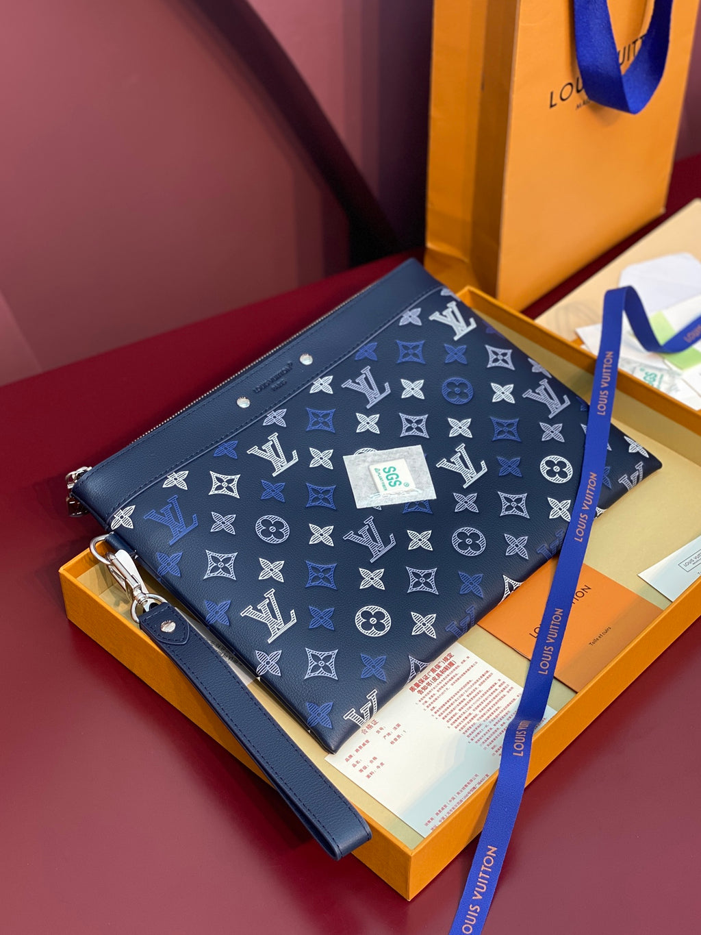 Blue Louis Vuitton small bag with monogram pattern, front flap, snap button closure.