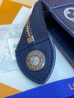 Louis Vuitton bag dark blue leather with circular logo snap and visible stitching