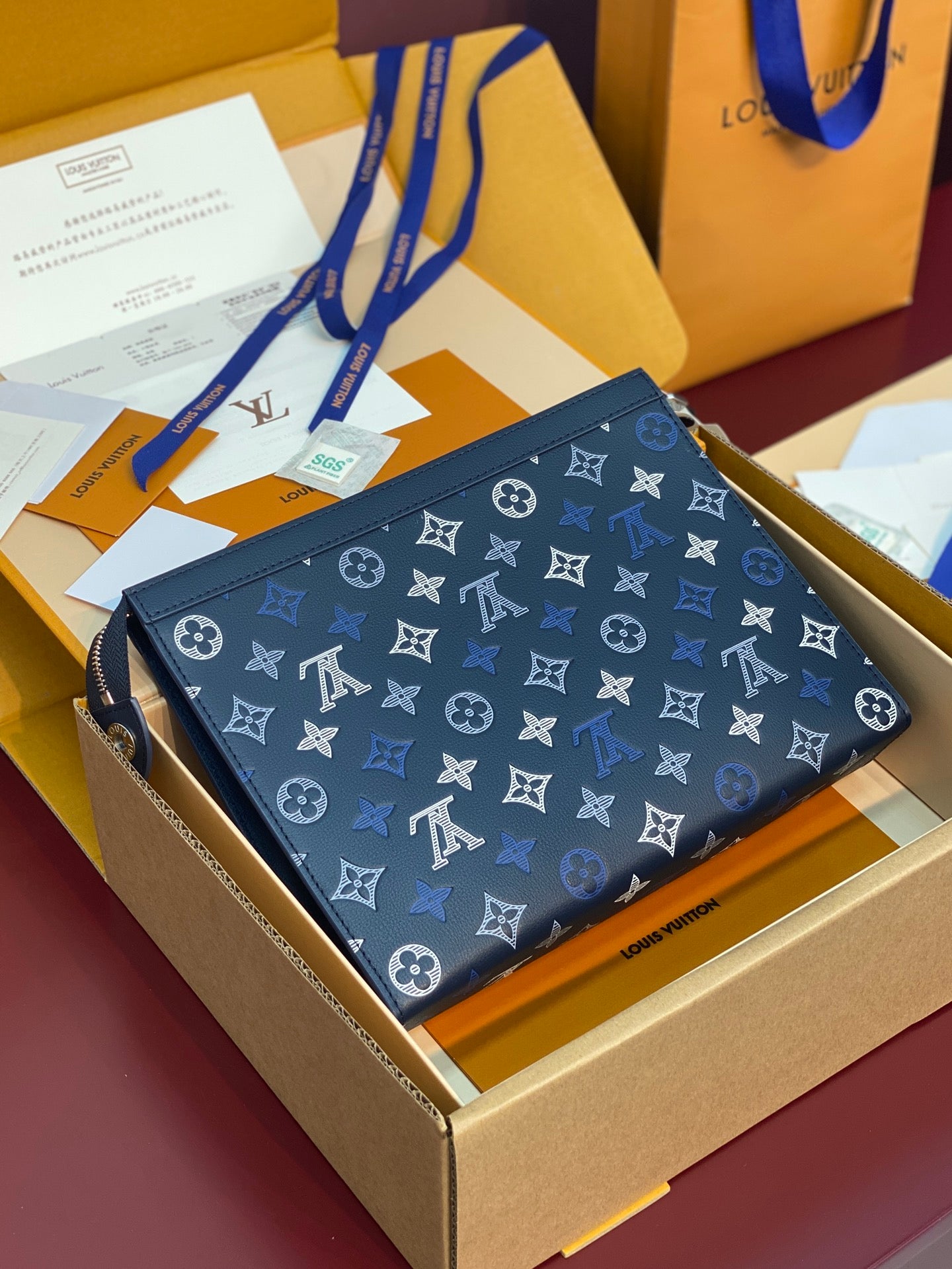 Blue monogram small bag with top zipper and patterned exterior