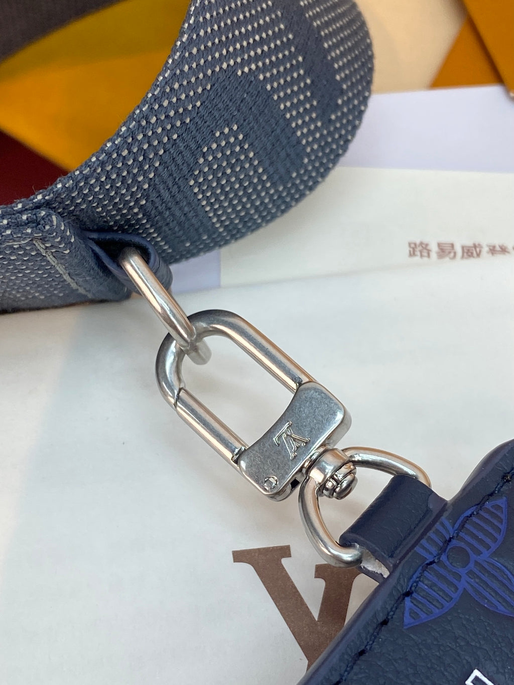 Blue Louis Vuitton crossbody strap with silver D-ring and clasp