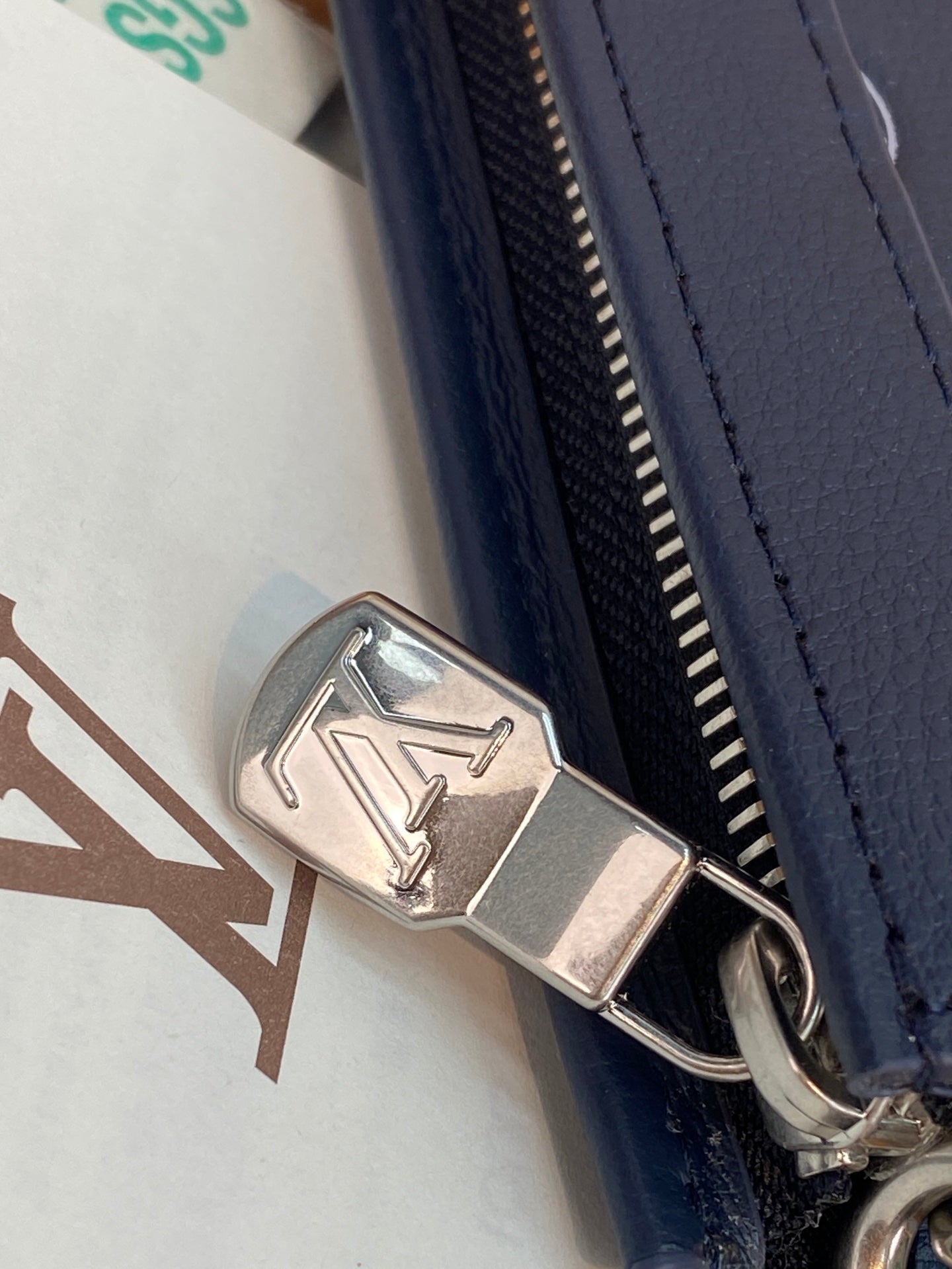 Navy small bag zipper with metallic logo pull and ring hardware