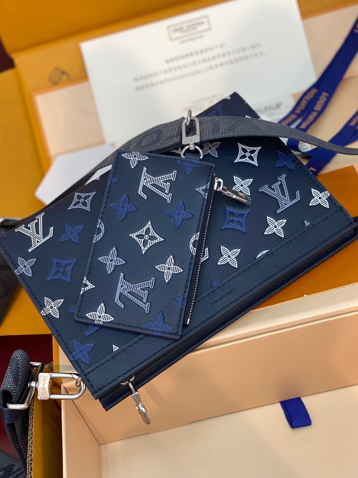 Blue Louis Vuitton small bag with zipper and white monogram pattern