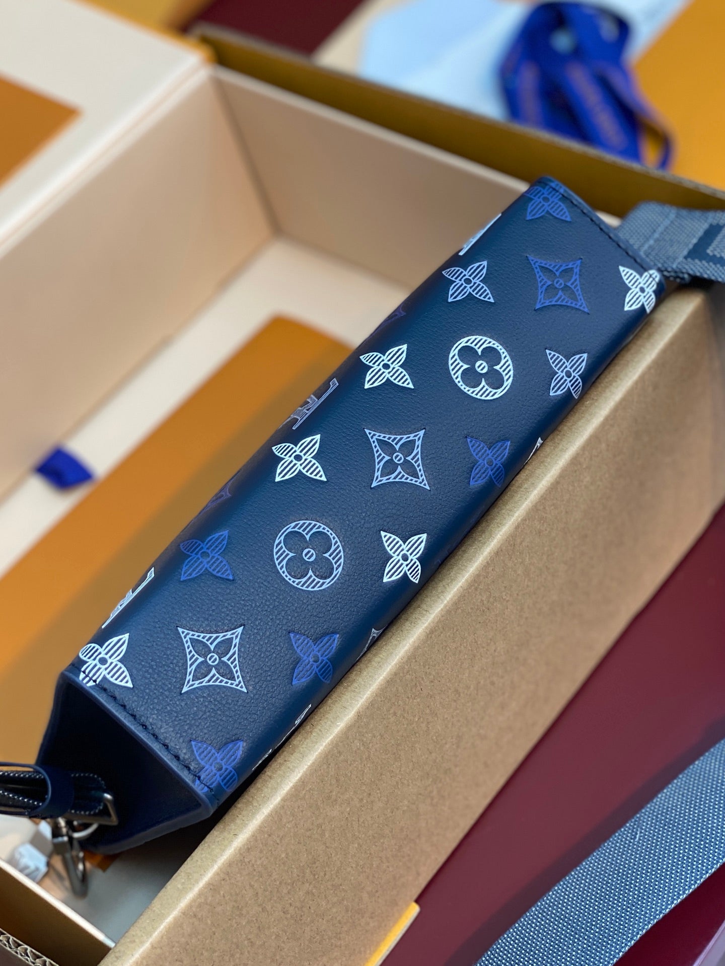 Blue Louis Vuitton long pouch with white monogram and bow motif pattern