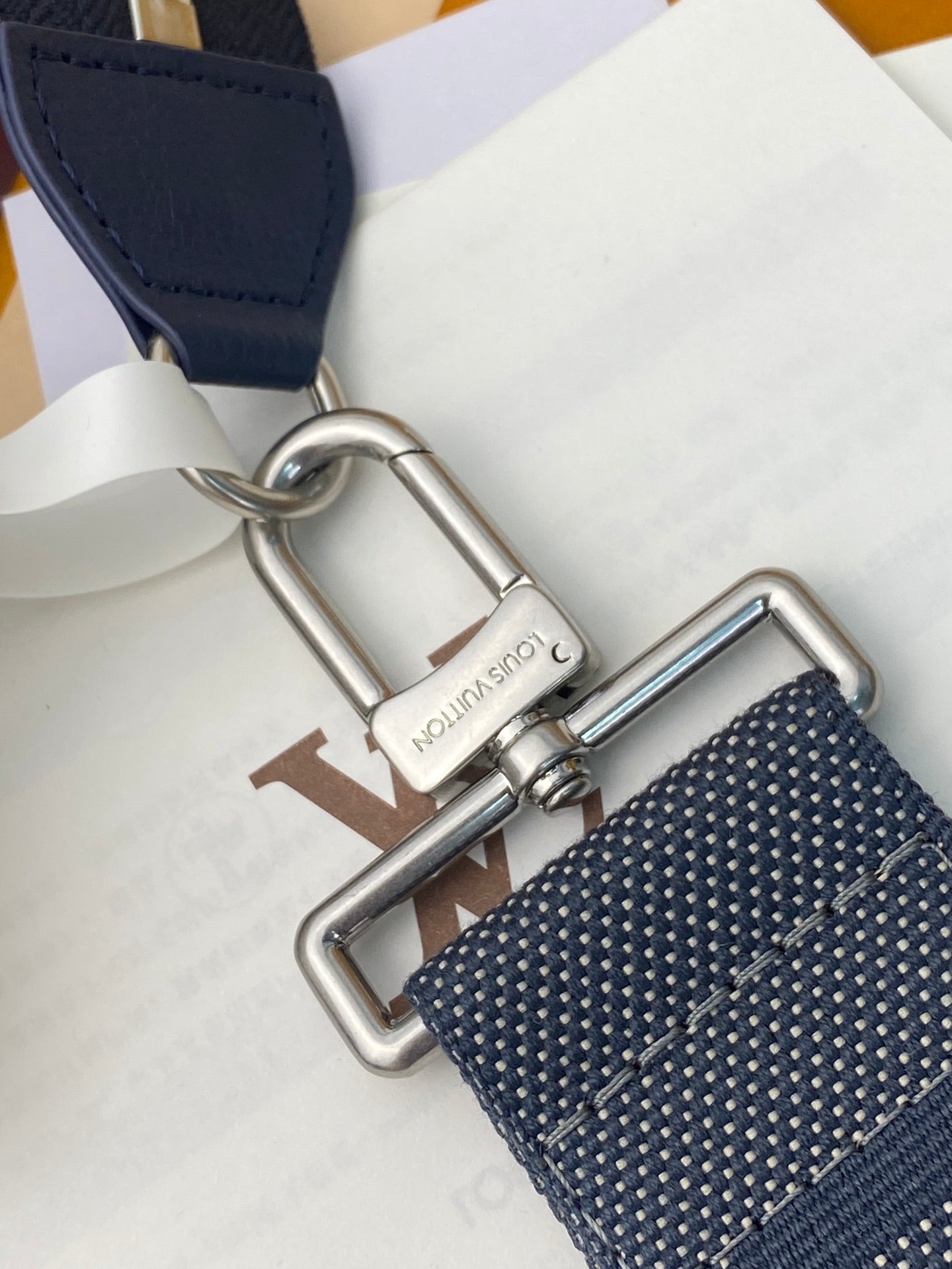 Blue Louis Vuitton strap with silver buckle hardware and textured weave
