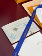 Louis Vuitton small bag with monogram print and long blue ribbon strap