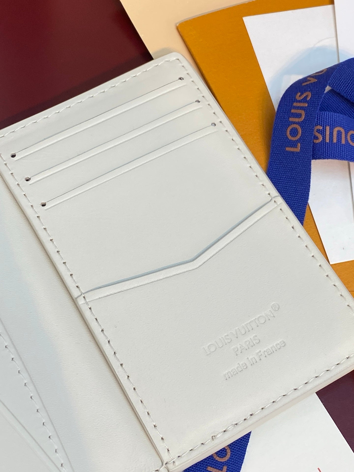 Men's Louis Vuitton small card wallet, interior close-up with white card pocket panel.