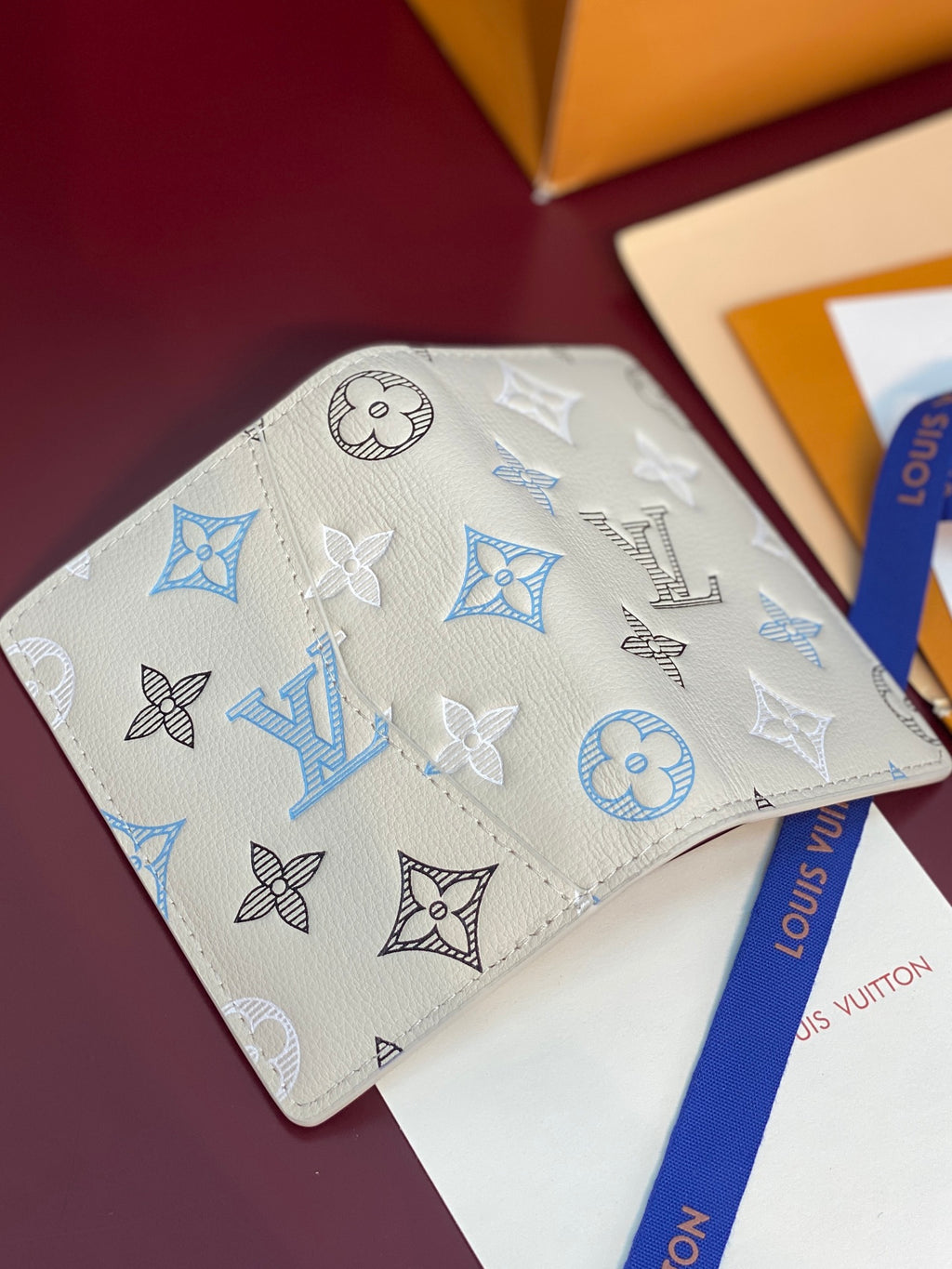 Louis Vuitton card holder, white leather with blue and black monogram icons