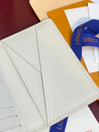 Men's Louis Vuitton small card wallet, interior panel close-up with stitched seams and center fold.