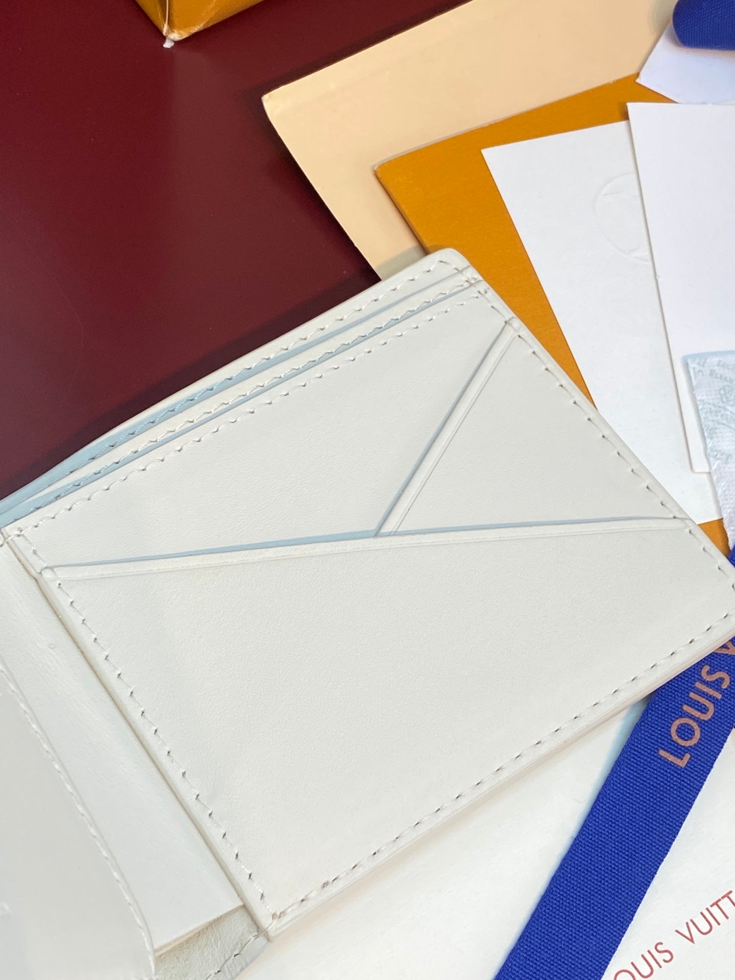 Louis Vuitton small bi-fold card holder, white interior with stitched border and card slots