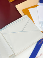 Louis Vuitton wallet interior, white card slots with stitched trim and panel seams.