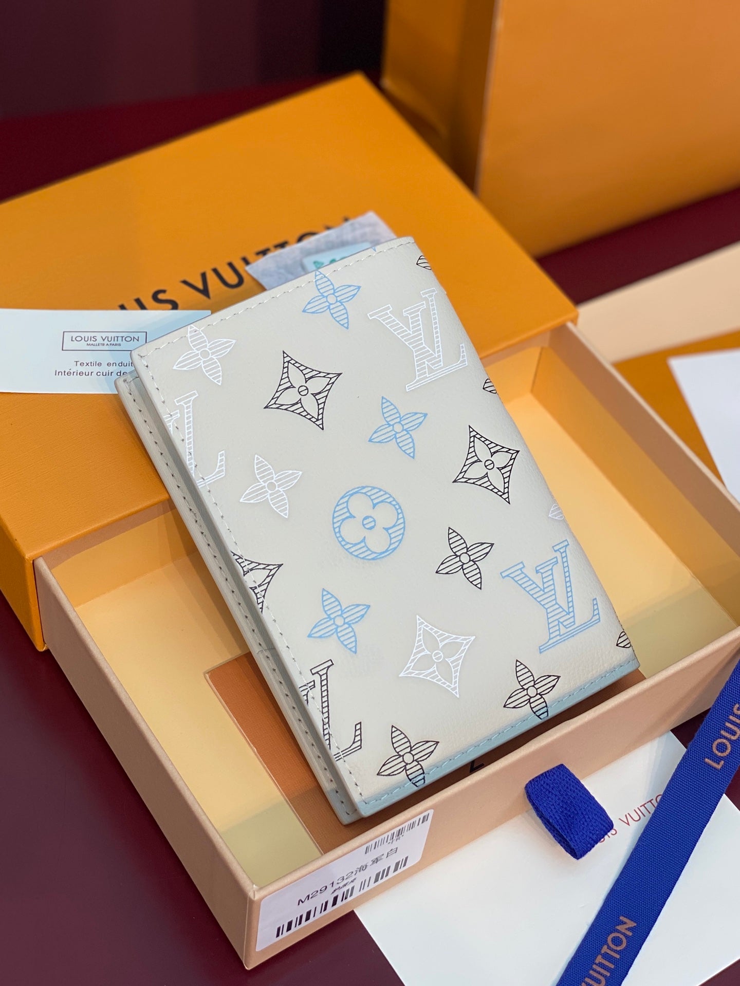 Men’s Louis Vuitton small wallet, light-blue monogram pattern on white leather