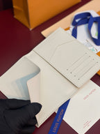 White bi-fold wallet open with card slots and center seam detail.